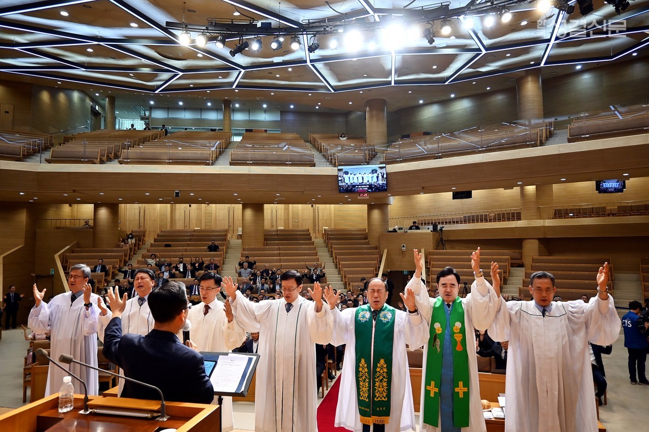 제118년차 총회 임원단이 단 위에 올라 회개의 기도를 드리고 있다.