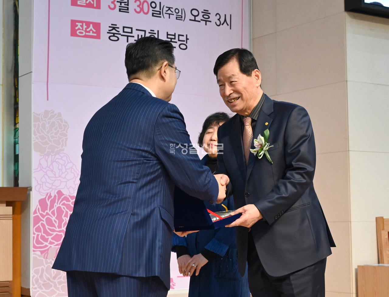 성창용 목사가 최현기 원로장로에게 원로장로 추대패를 전달하고 있다.